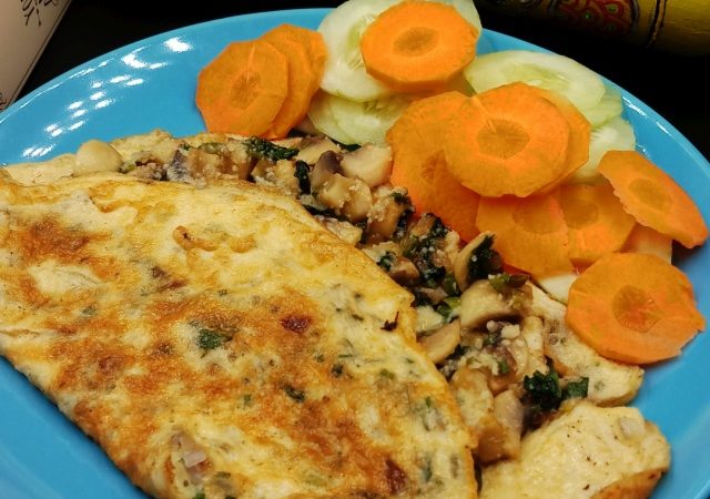 A golden-brown delicious stuffed omelette recipe served with a side of salad.