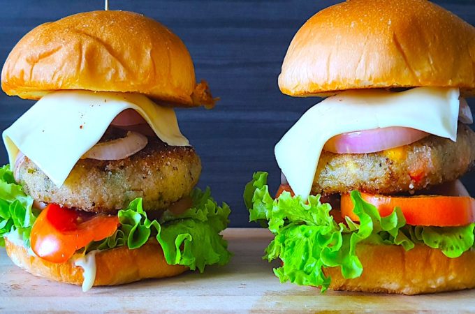 Mouthwatering veg burger recipe with lettuce, tomato, onion, cheese, and a seasoned veggie patty served on a toasted bun.
