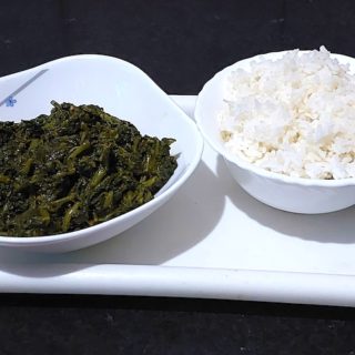 A bowl of homemade Palak Ka Saag with white rice.