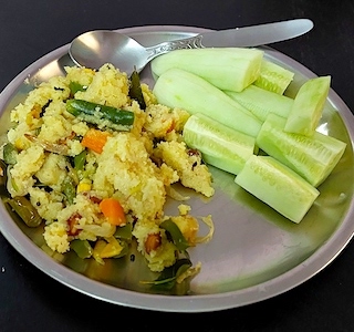 A plate of Sooji Upma garnished with fresh coriander leaves