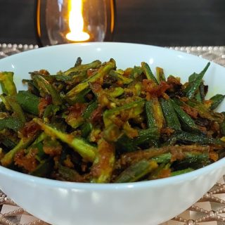 A bowl of crispy Kurkuri Bhindi, a popular Indian dish made from raw bhindi with a spicy coating.