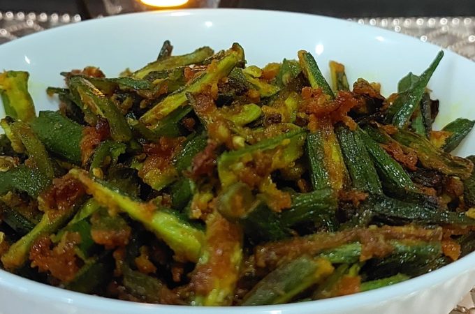 A bowl of crispy Kurkuri Bhindi, a popular Indian dish made from raw bhindi with a spicy coating.