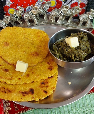 A plate of Sarson ka Saag served with makki di roti.
