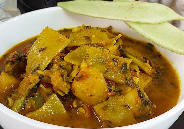 Aloo Sem ki Sabji – Delicious Potato and Flat Bean Curry. Serve in white bowl.