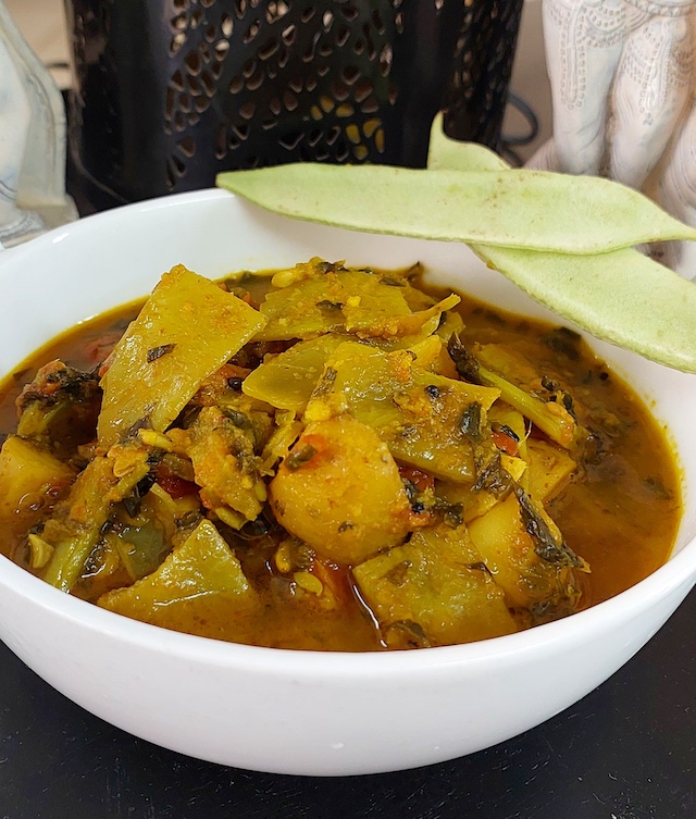 Aloo Sem ki Sabji Recipe – Delicious Potato and Flat Bean Curry.  Serve in white bowl.