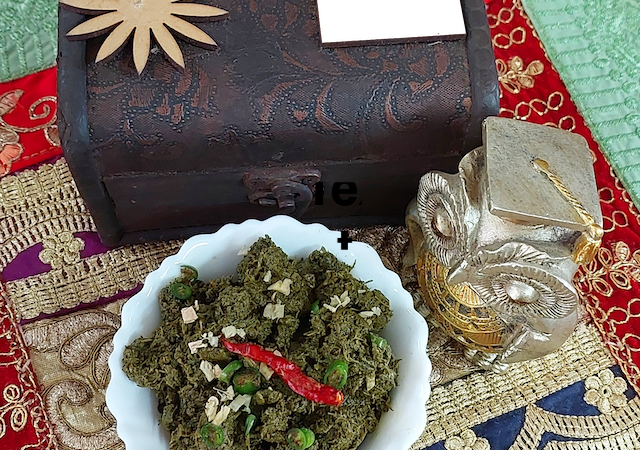 A bowl of homemade chane ka saag, a flavourful chane ka saag and bathua saag, garnished with fresh chopped ginger & chopped green chilies.