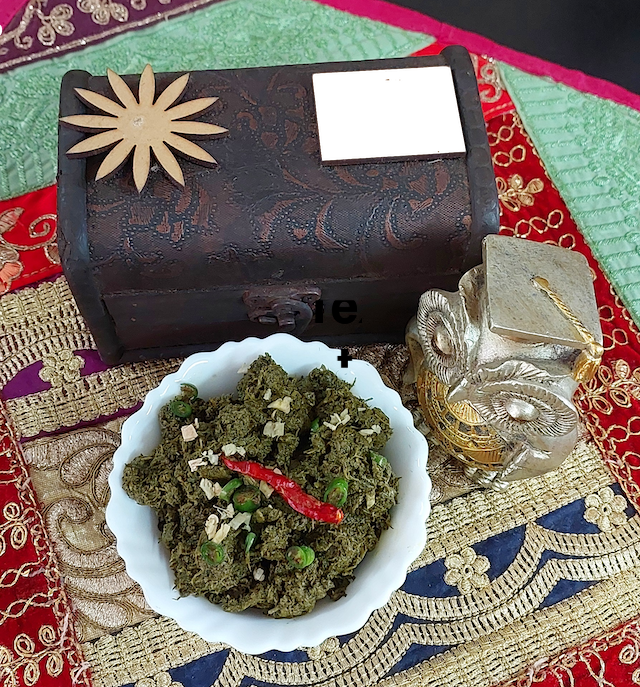 A bowl of homemade chane ka saag, a flavourful chane ka saag and bathua saag, garnished with fresh chopped ginger & chopped green chilies.