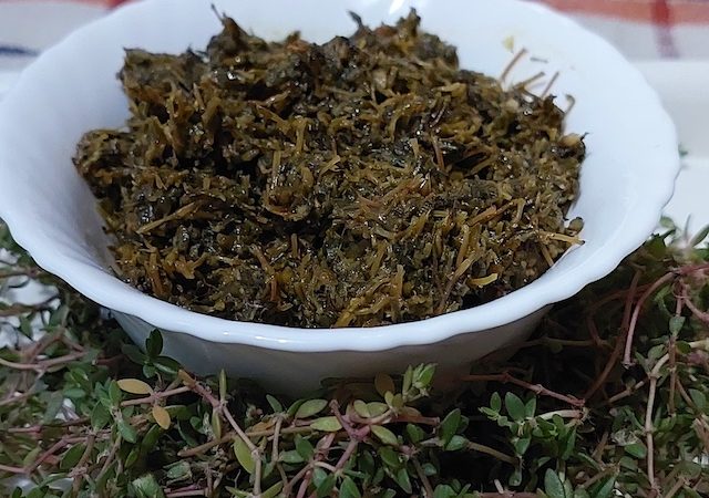 Noni ka saag is fresh green leaves being chopped for a delicious and nutritious Indian greens dish.