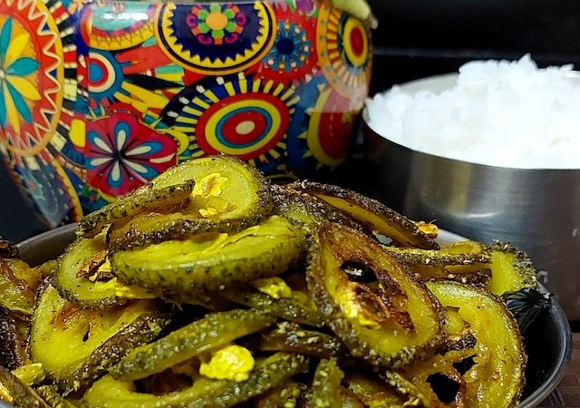 A plate of golden-brown Spiny Gourd Fry, showcasing the crispy texture.