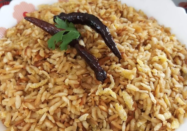 Roasted Chivda (Bhuna Chivda) served in white bowl with dry red chili.