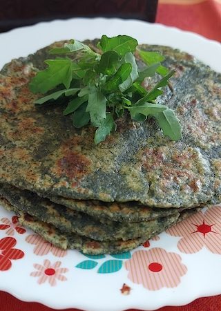 Bathua Saag Parathas Recipe served on a plate, garnished with bathua leaves.