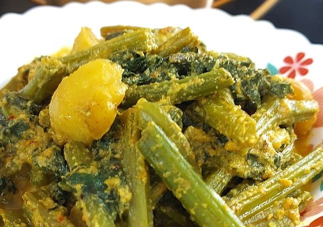 Bottle Gourd Leaves Curry / Lau Shak Recipe served in white bowl.