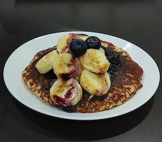 Blueberry sauce drizzled over pancakes.