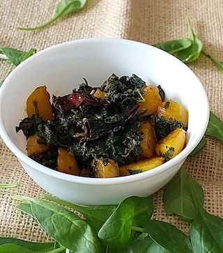Dry Aloo palak sabji served in a bowl 